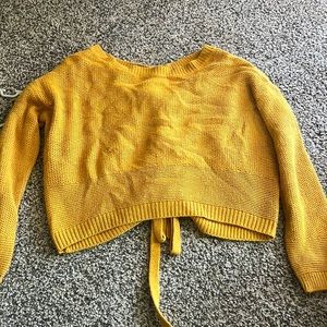 cute cropped yellow sweater, criss cross & ties in the back, hardly been worn.